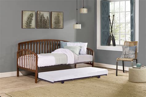 Cottage inspired wood full-sized daybed with twin-sized trundle featuring an arched design, and beadboard styling; Traditional wood frame features a classic white finish; Includes daybed and pull out trundle; one full-sized and one twin mattresses required, not included; Dimensions: 34.25H X 79.75W X 56.75D; Trundle: 13.25H X 77.25W X 40.5D 